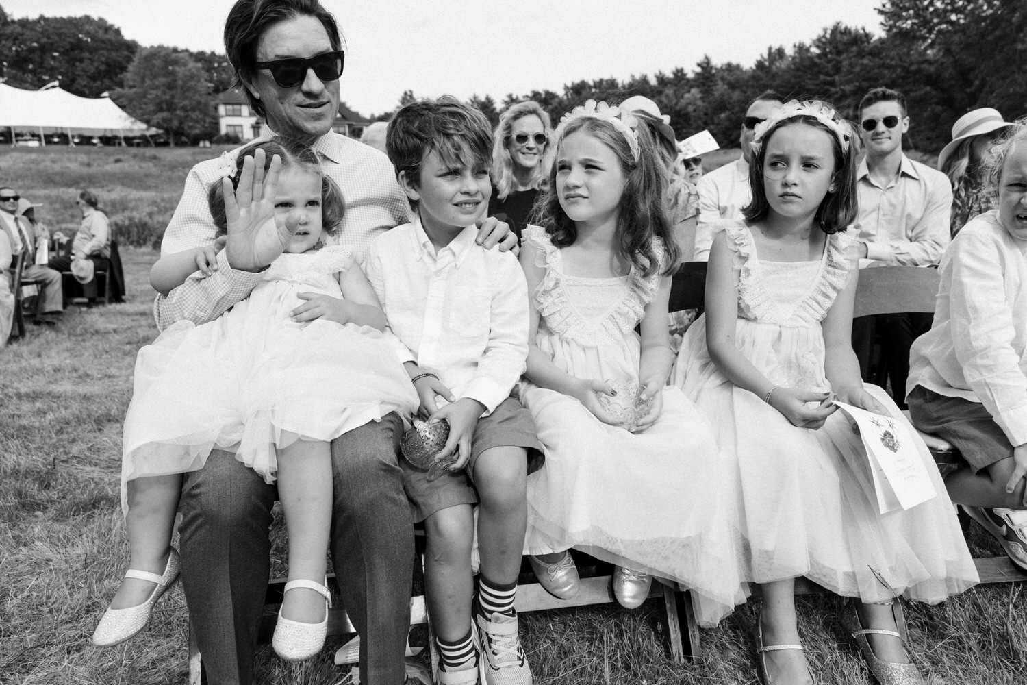 Flower girls and ring bearers look on during a sunny wedding ceremony in Saco, Maine