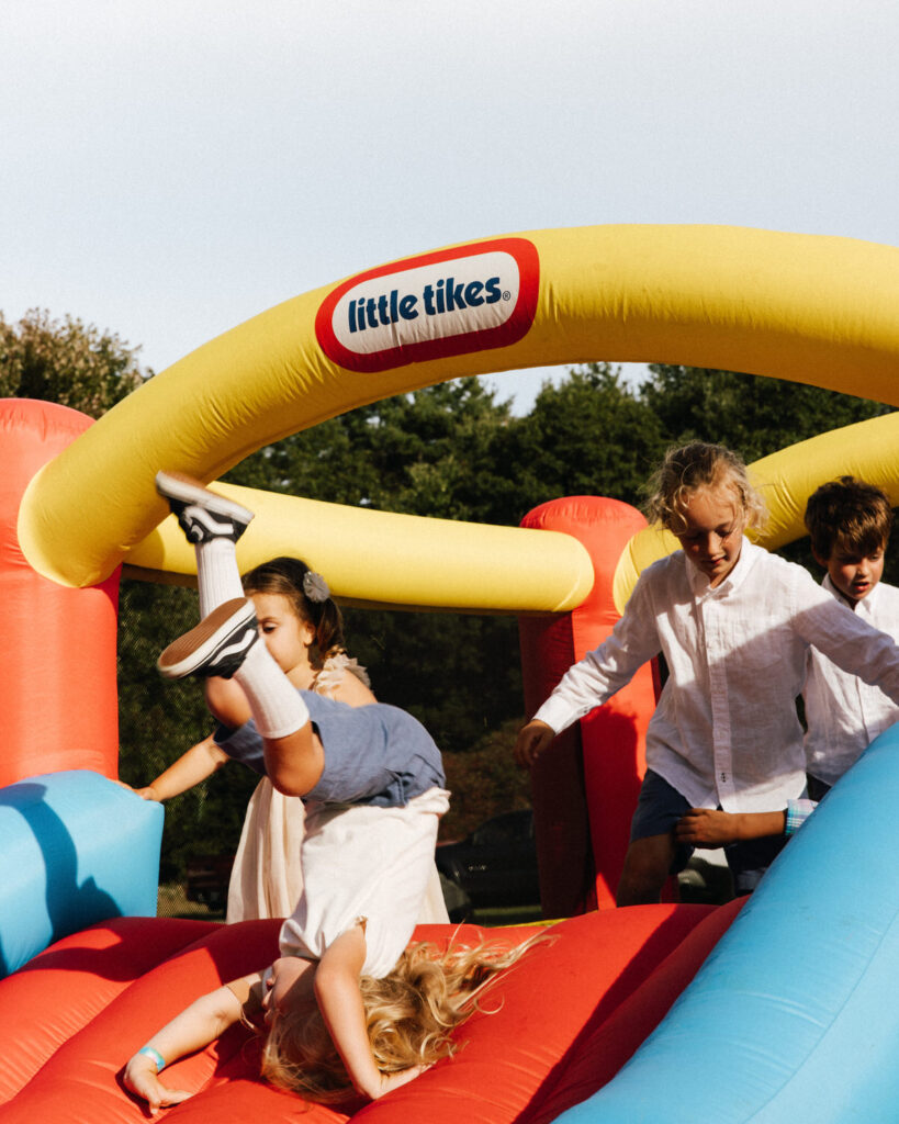 Kids play in little tikes blow up structure during wedding reception