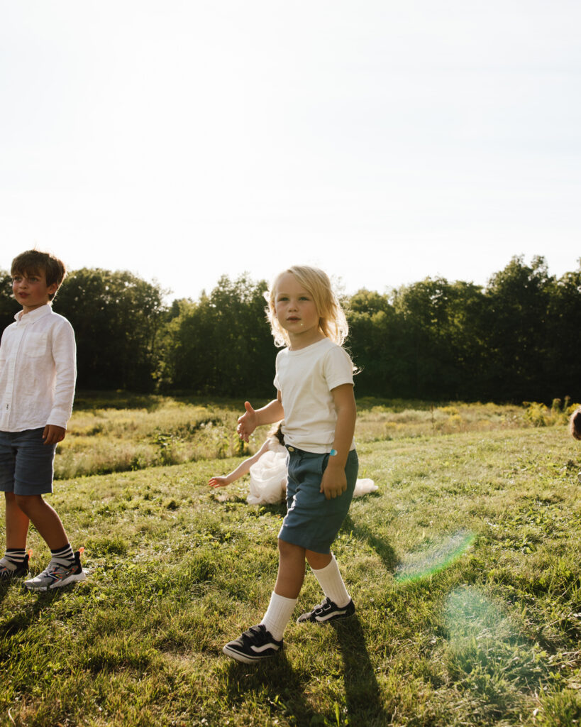 Kids running around during family photos on the wedding day